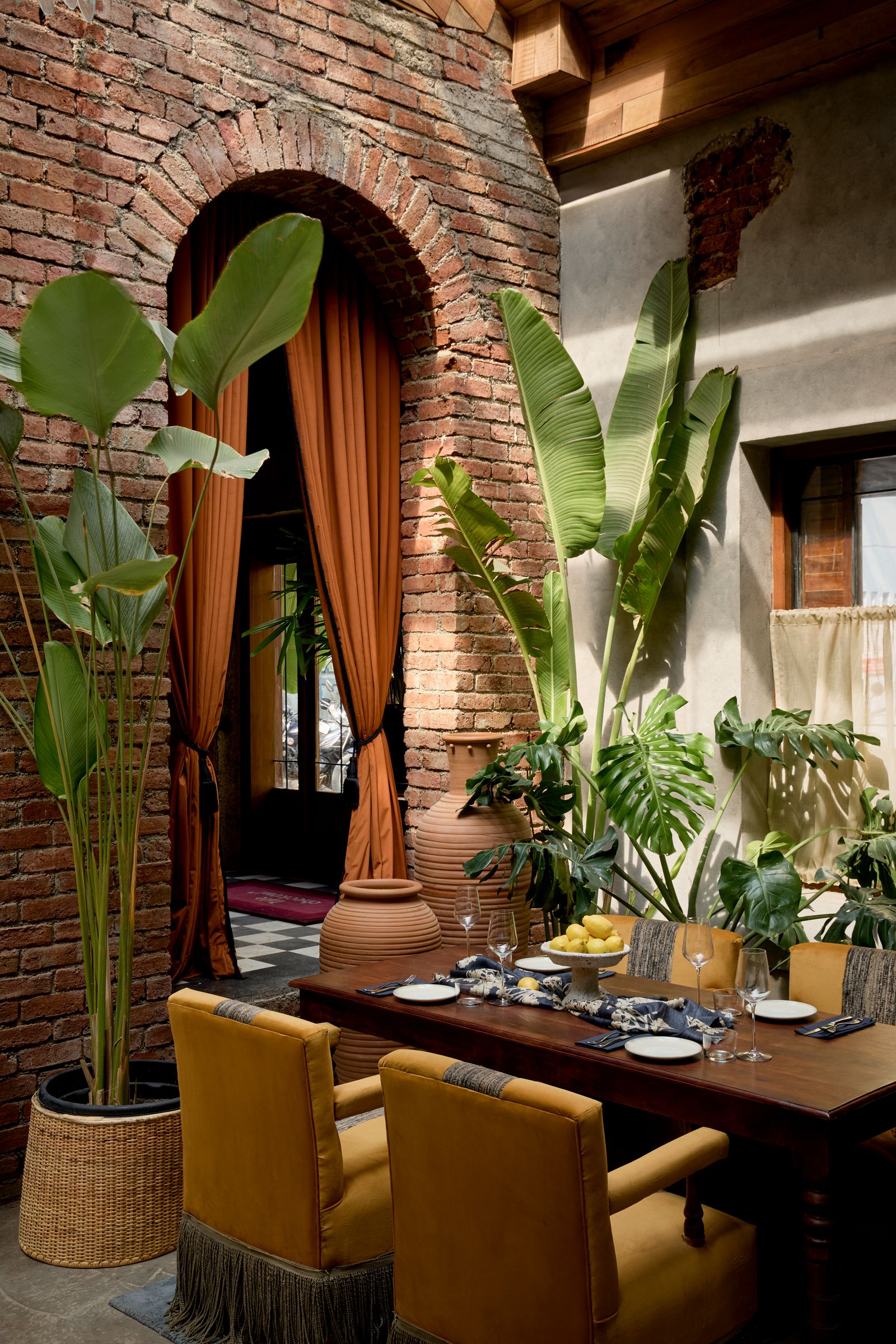 Image may contain Indoors Interior Design Dining Table Furniture Table Plant Architecture Building and Dining Room