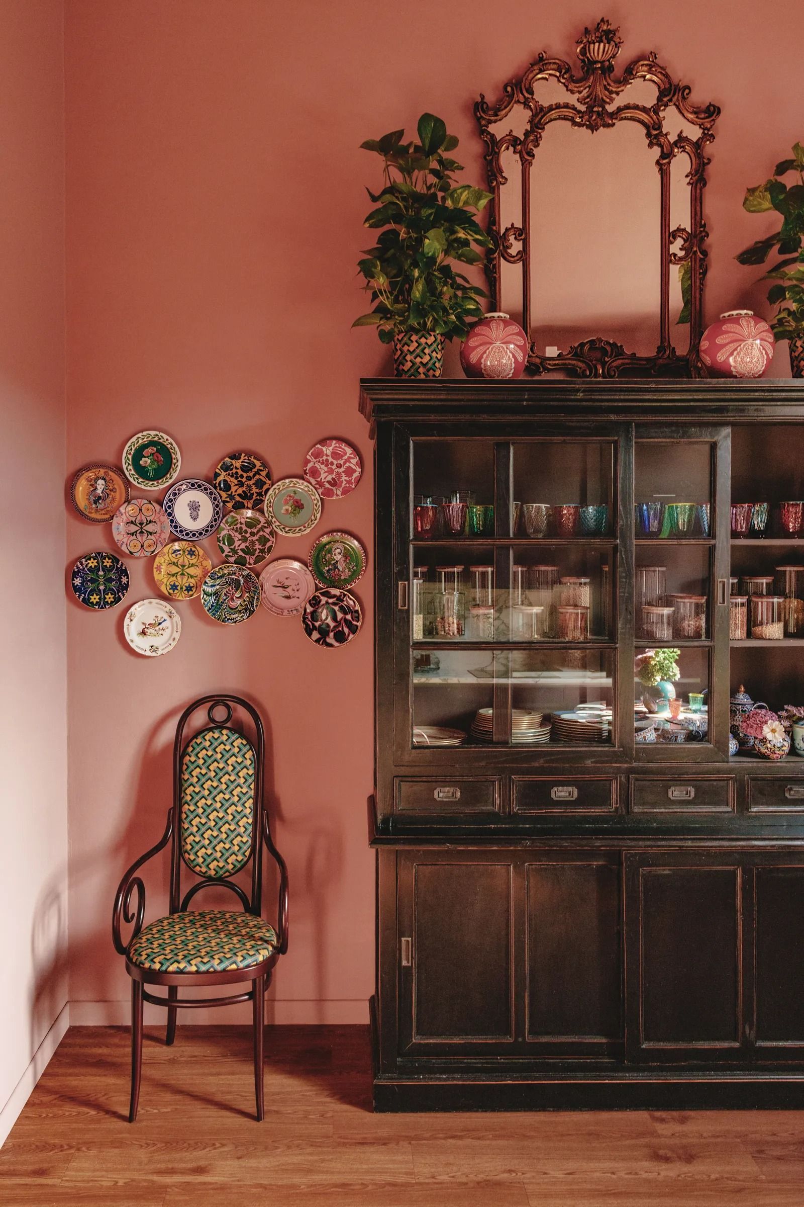 Image may contain Chair Furniture Indoors Interior Design Plant Cabinet Shelf China Cabinet Plate and Cup