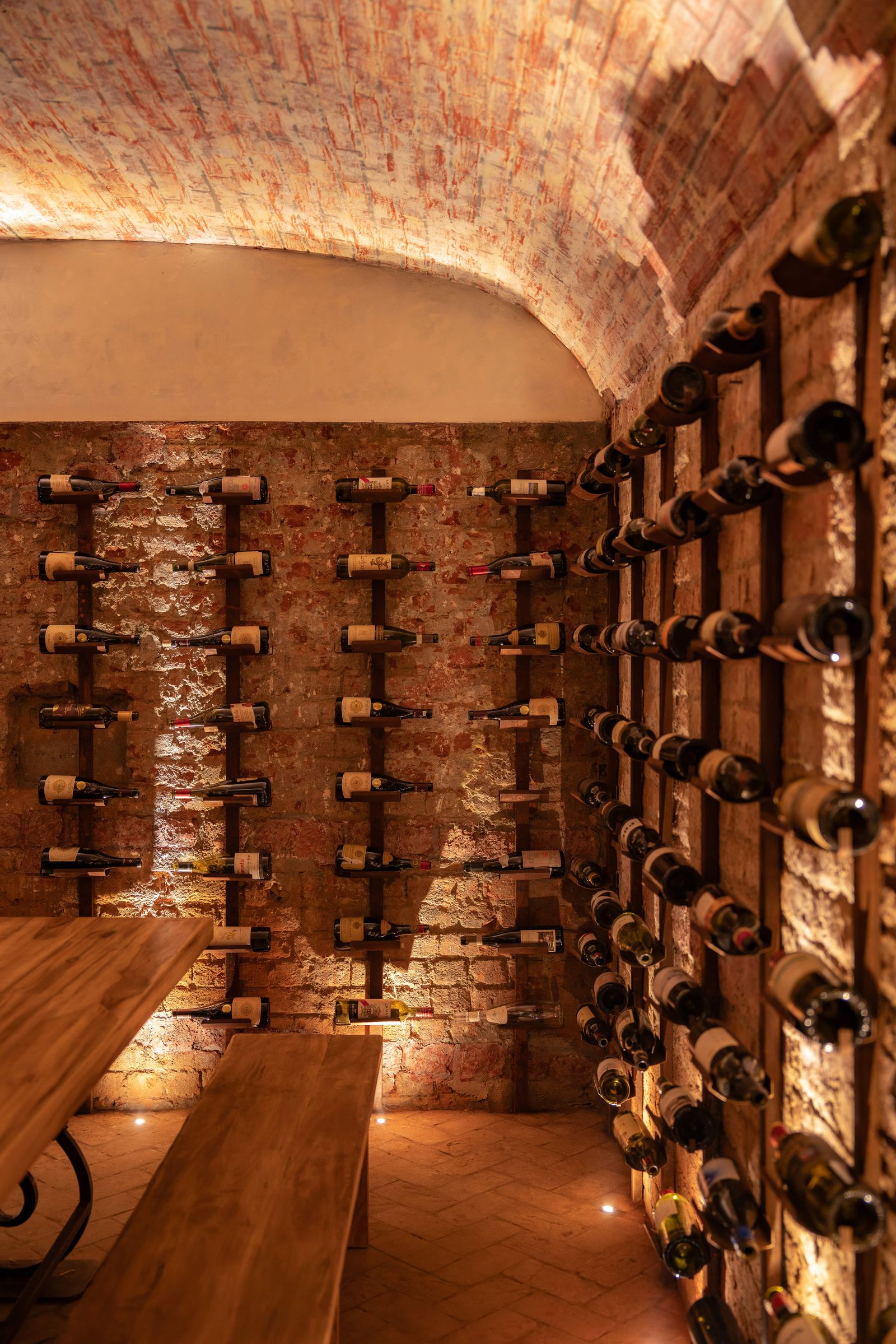 Image may contain Alcohol Beverage Liquor Wine Desk Furniture Table Wine Cellar and Bench