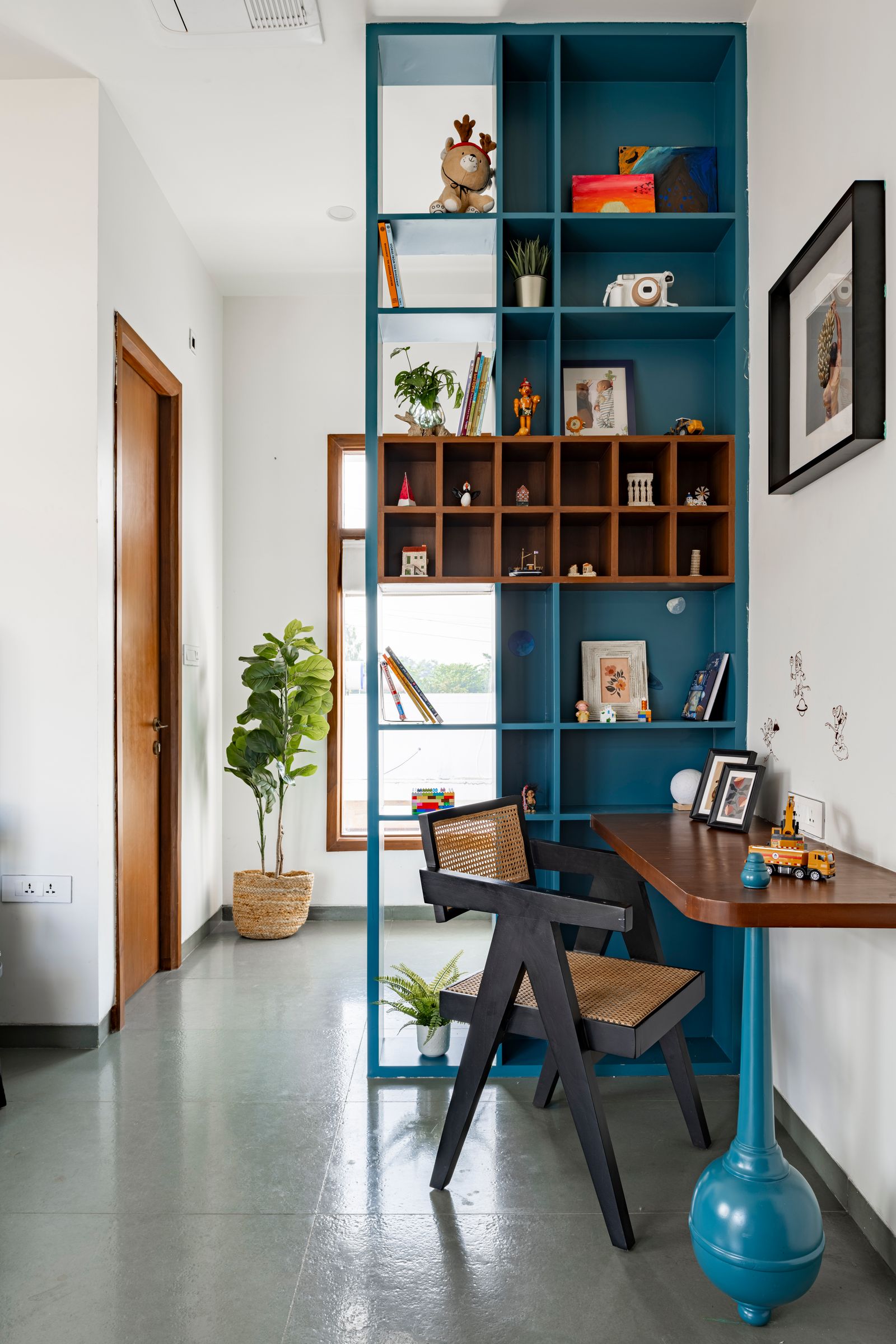 Image may contain Chair Furniture Plant Table Indoors Interior Design Toy Art Painting Desk Bookcase and Person