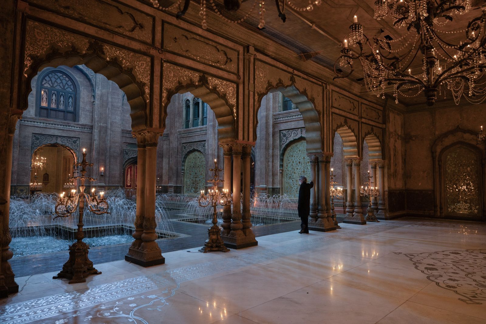 Image may contain Lamp Ballroom Indoors Room Person Floor Chandelier Flooring Arch and Architecture