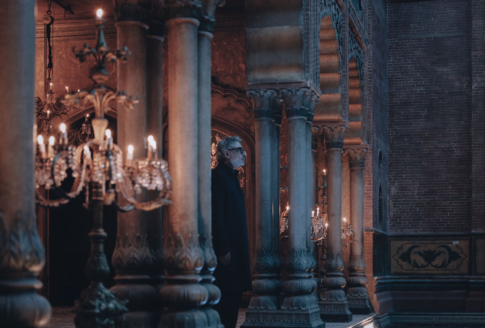 Image may contain Chandelier Lamp Person Crypt Prayer Festival and Hanukkah Menorah