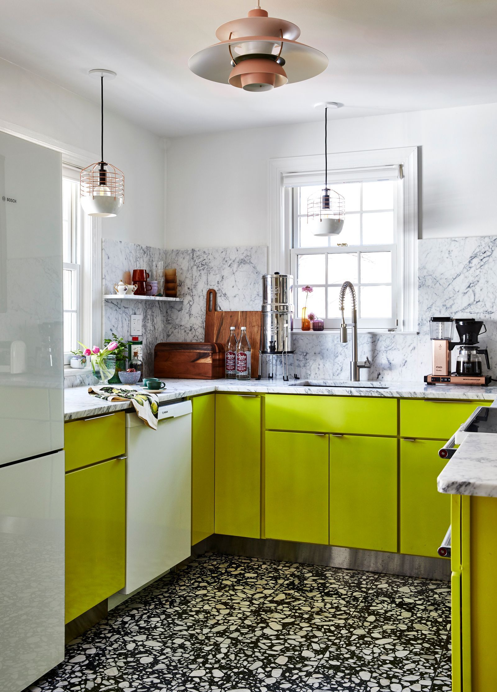 Image may contain Indoors Kitchen Interior Design Lamp Sink Sink Faucet Home Decor Cup and Chandelier