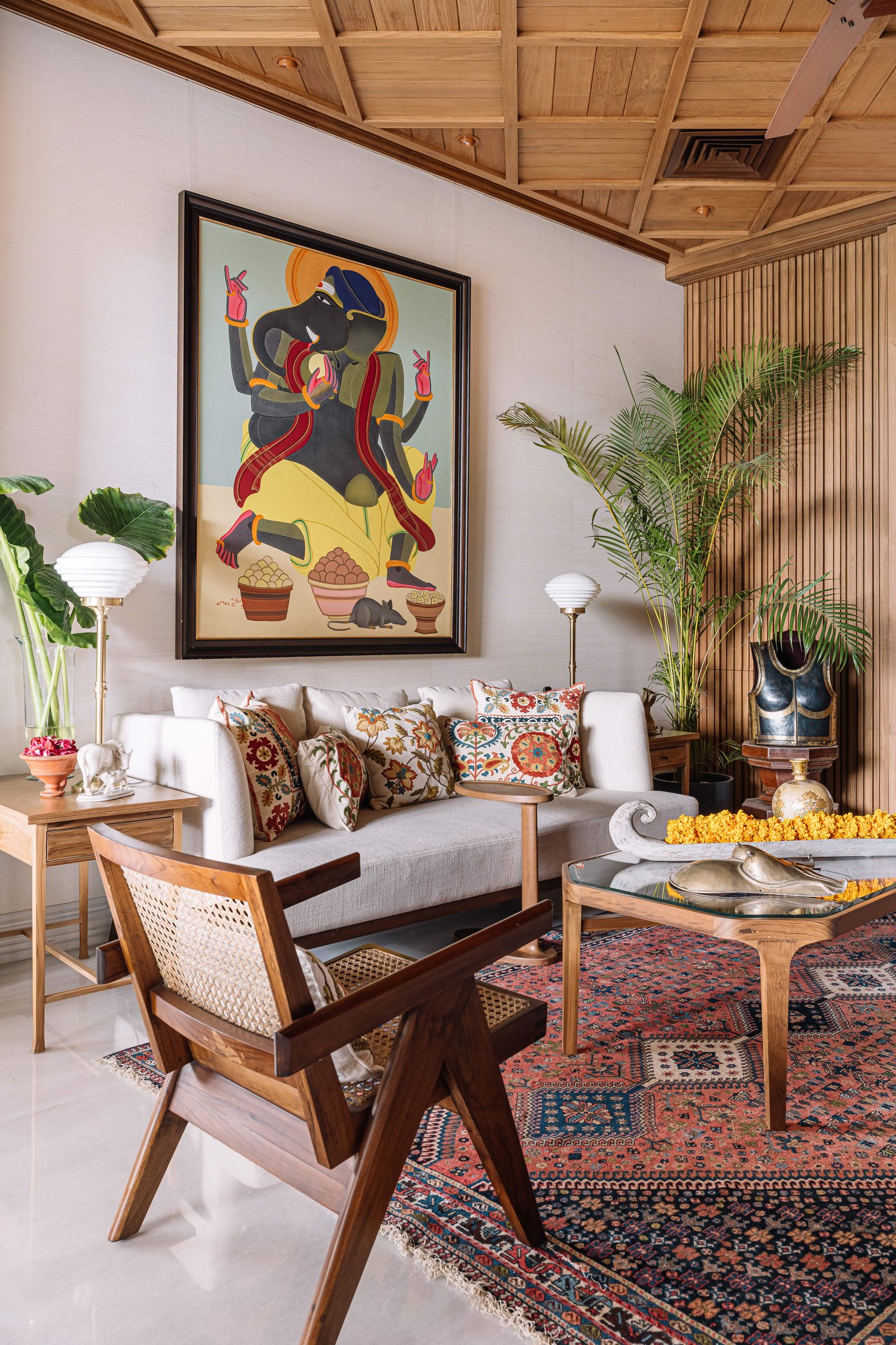 Image may contain Home Decor Indoors Interior Design Rug Plant Lamp Furniture Table Chair Couch and Architecture