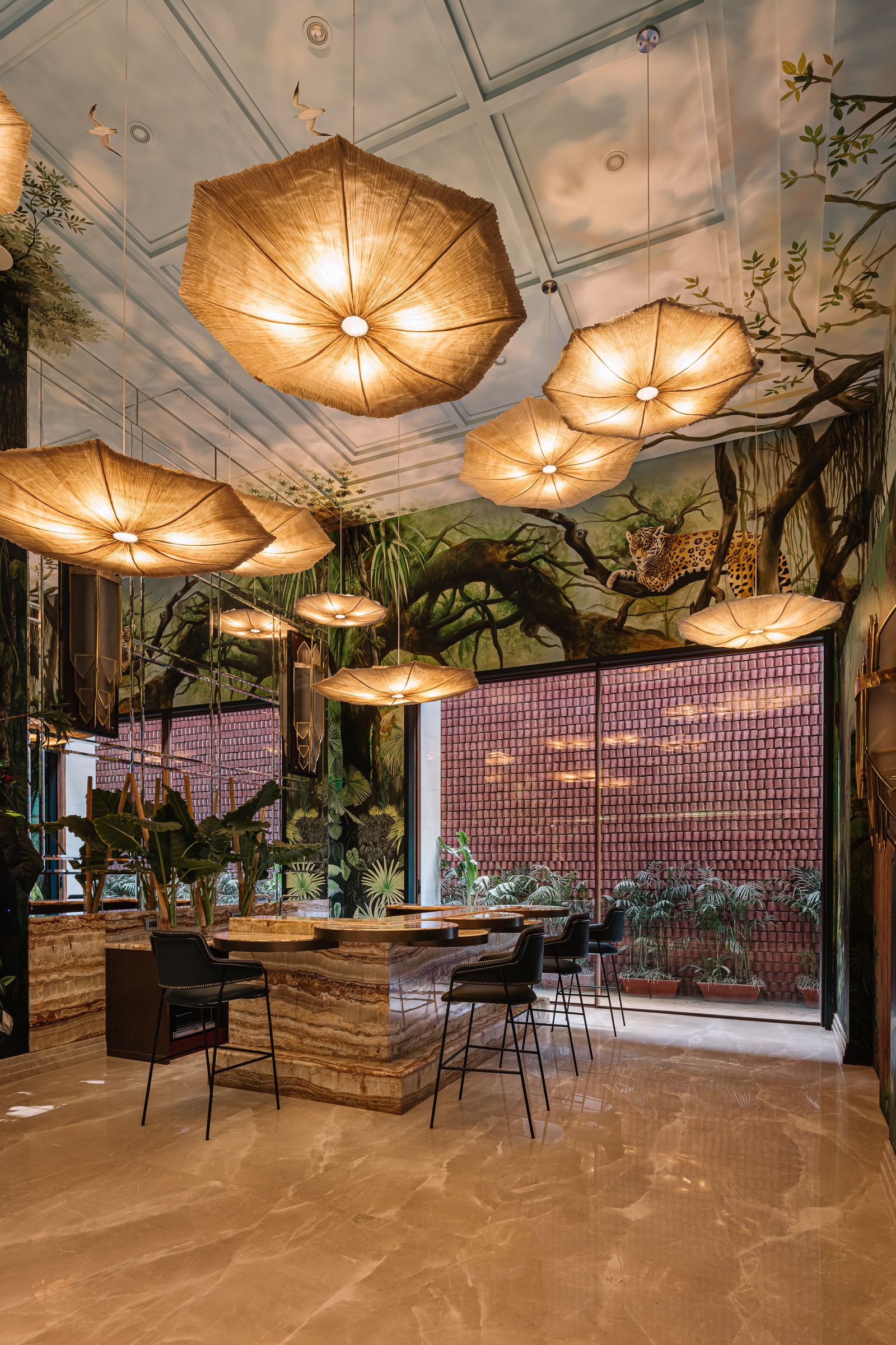 Image may contain Floor Indoors Architecture Building Foyer Chair Furniture Lamp Plant Desk and Table