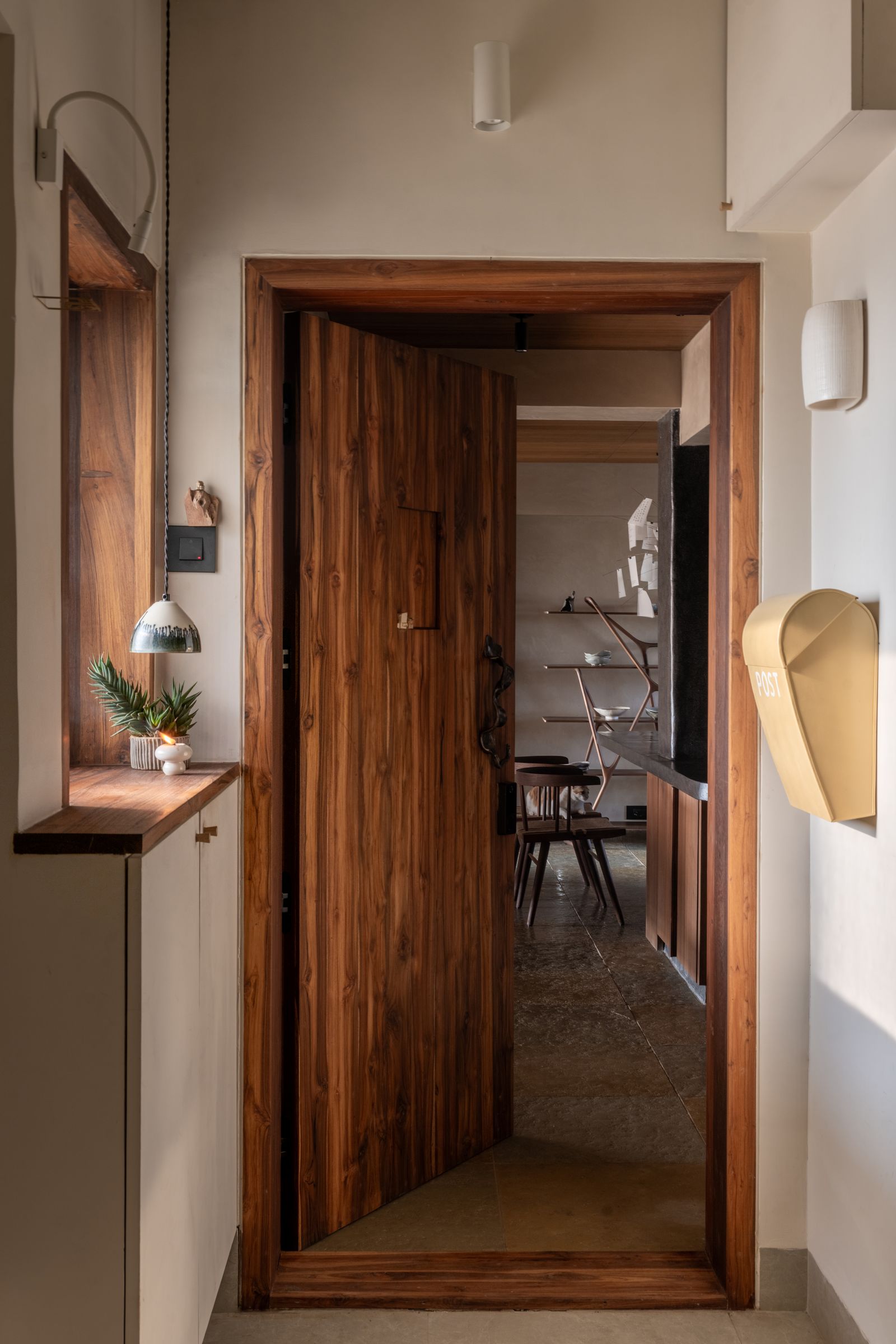 Image may contain Indoors Interior Design Hardwood Wood Stained Wood Door Lamp Wood Panels Chair and Furniture