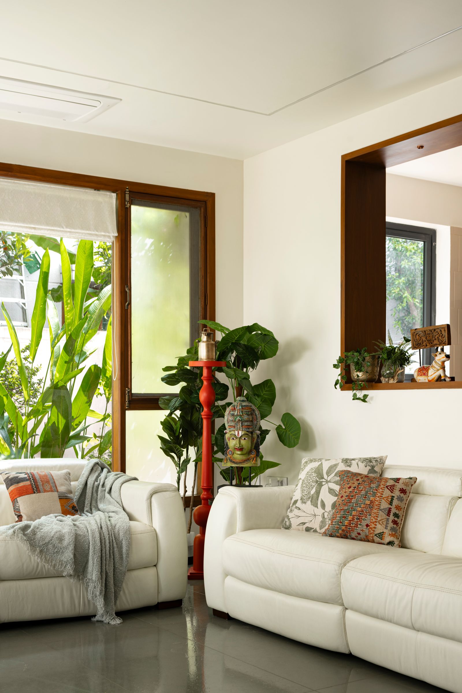 Image may contain Architecture Building Furniture Indoors Living Room Room Couch Plant Potted Plant and Home Decor