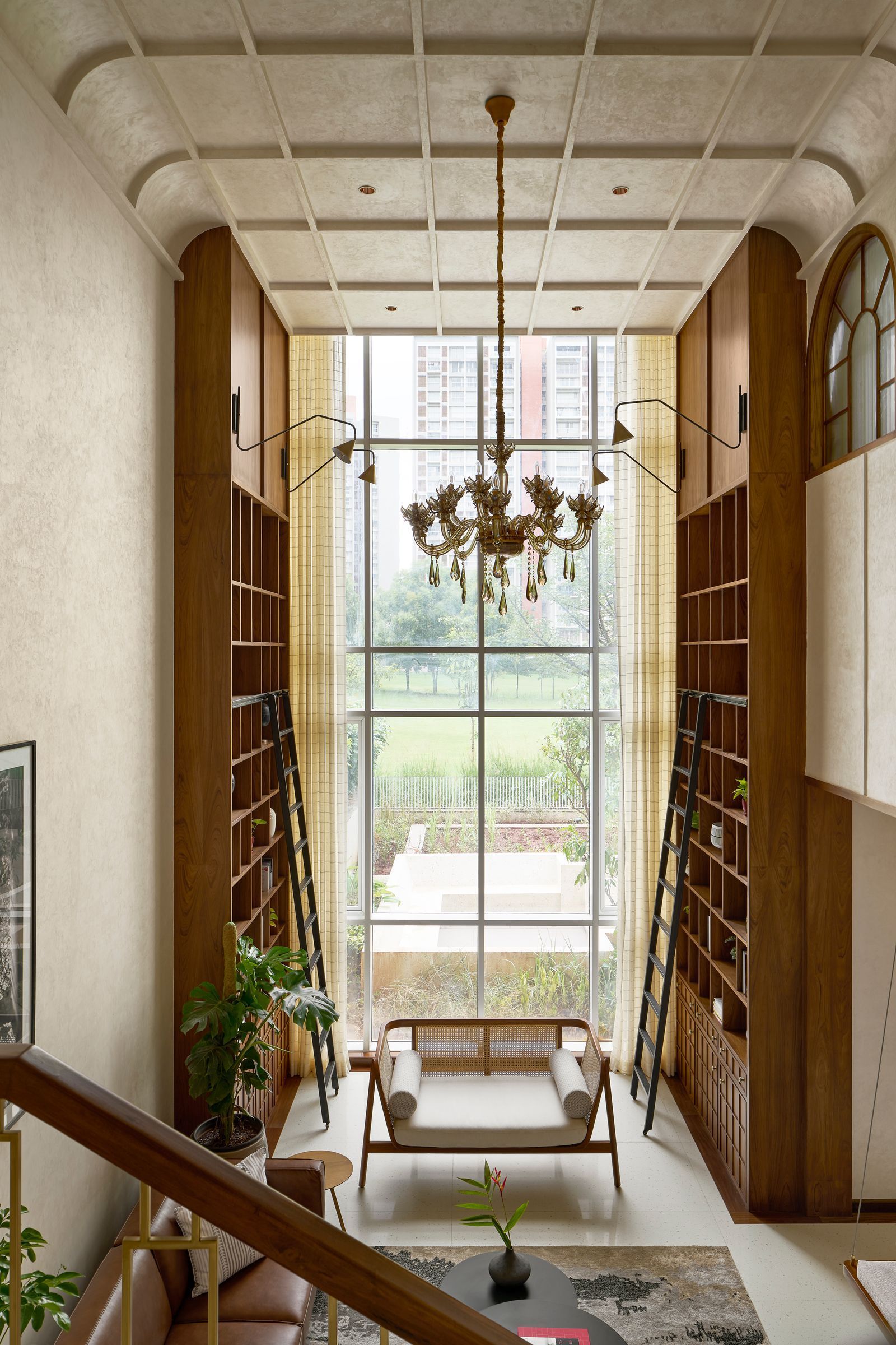 Image may contain Plant Indoors Interior Design Lamp Chandelier Bench Furniture Home Decor Rug and Architecture