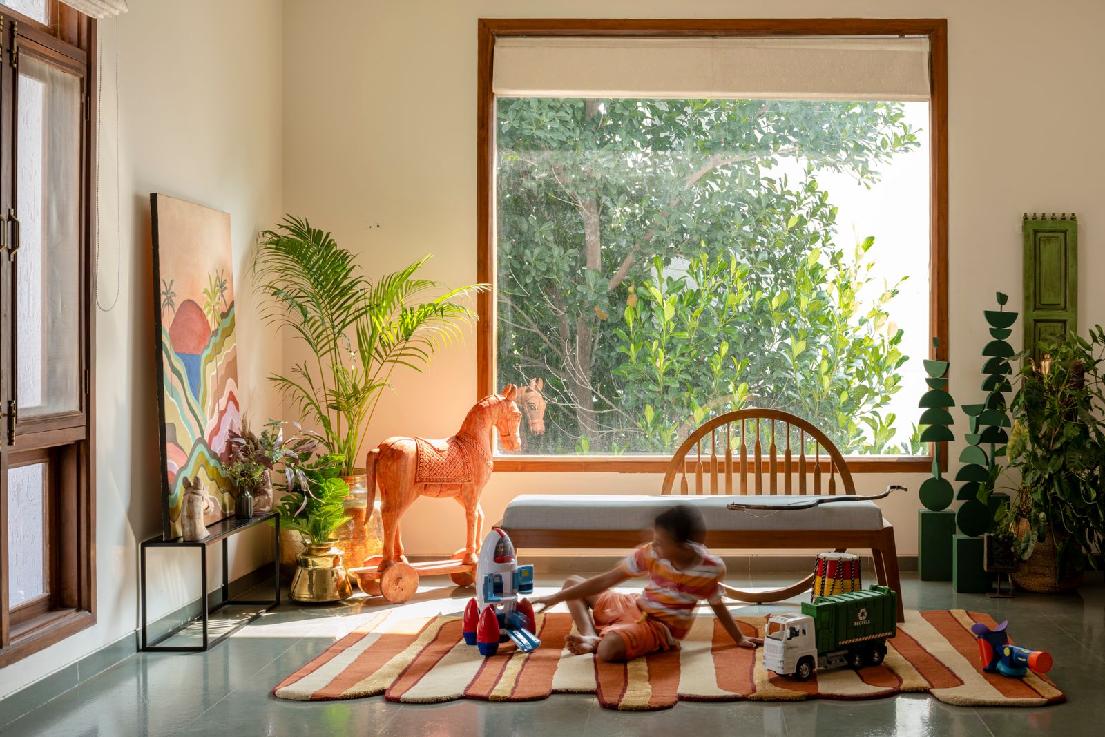 Image may contain Architecture Building Furniture Indoors Living Room Room Child Person Plant Home Decor and Desk