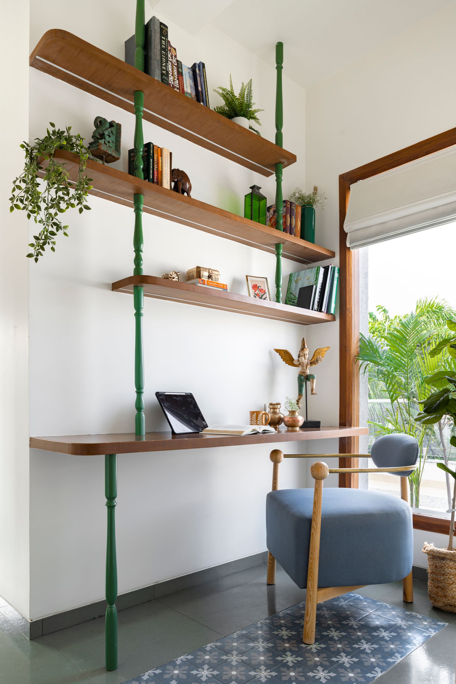 Image may contain Furniture Plant Home Decor Rug Bookcase Chair Art Painting Computer Electronics Laptop and Pc