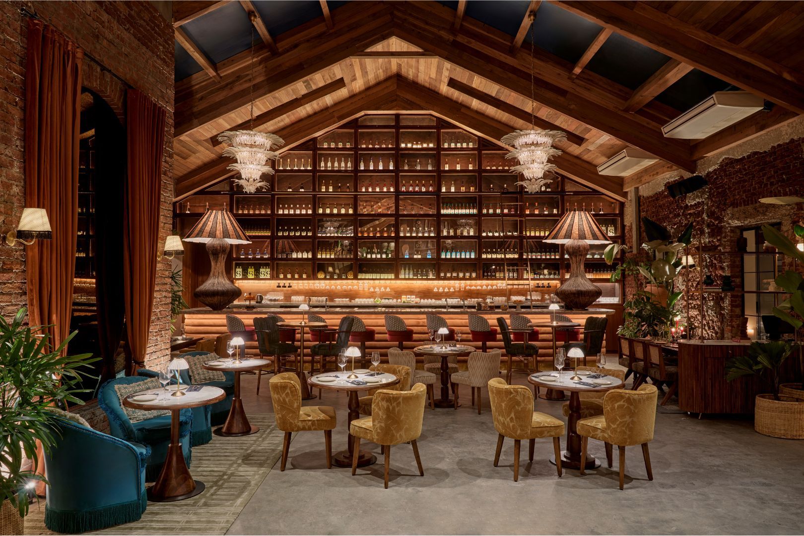Image may contain Lamp Plant Chair Furniture Desk Table Bar Indoors Interior Design new cocktail bar and Dining Table